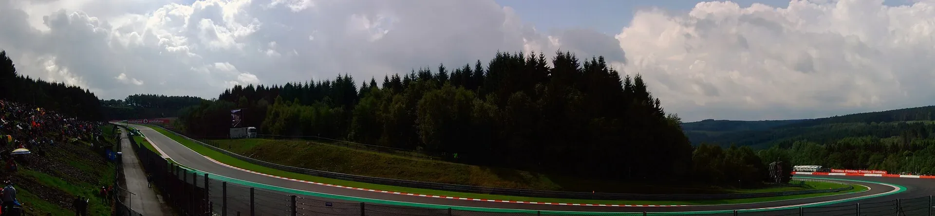 The Pouhon section of Spa-Francorchamps surrounded by wooded hills.