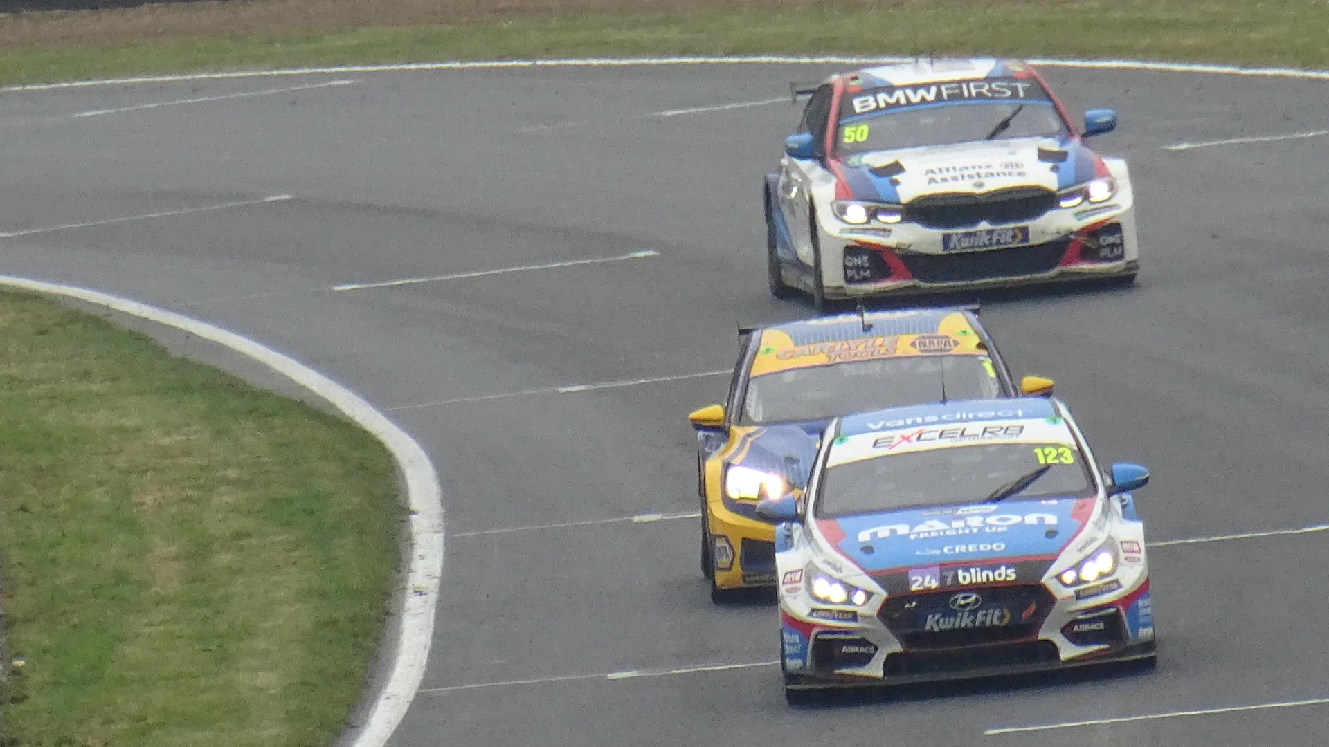 Touring cars racing in wet conditions at Brands Hatch during the 2022 British Touring Car Championship.
